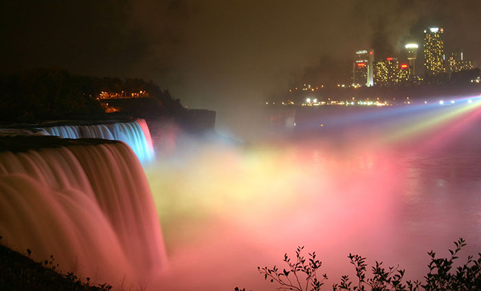 Niagara Falls lit up at night with colours