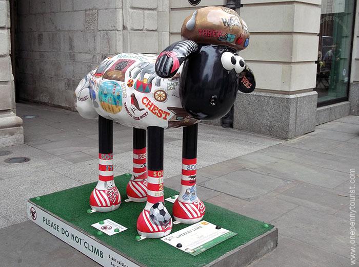 Literary Lamb Shaun is covered in words with double meanings and matching caricatures. Part of the Shaun in the City Art Trail in London.